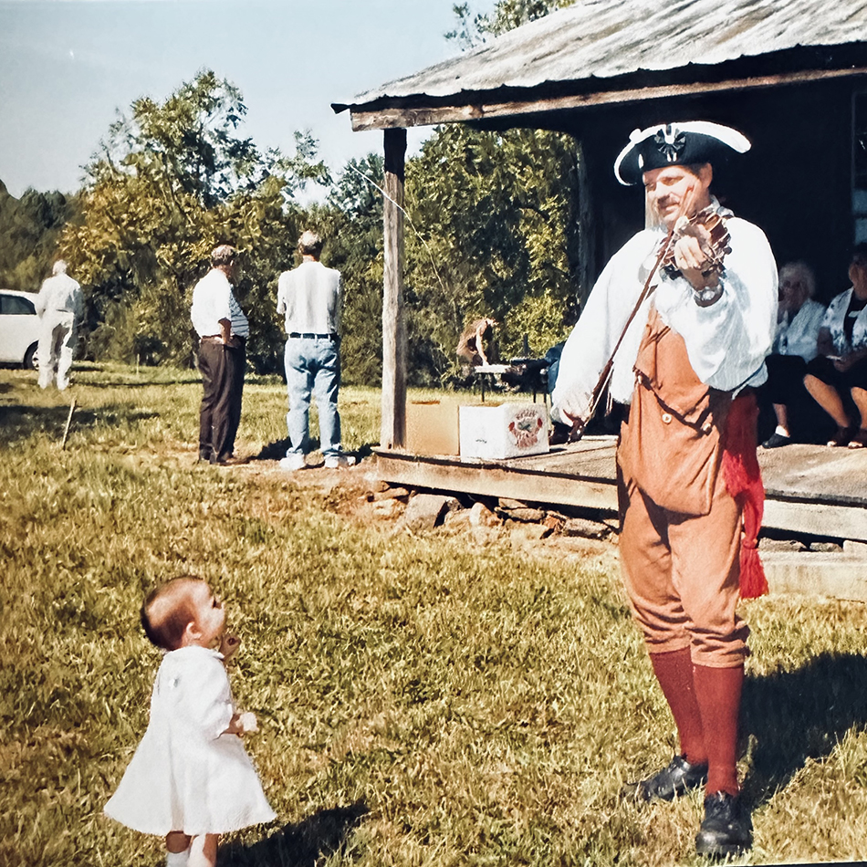 contribute image Image of man playing fille while a small child watches